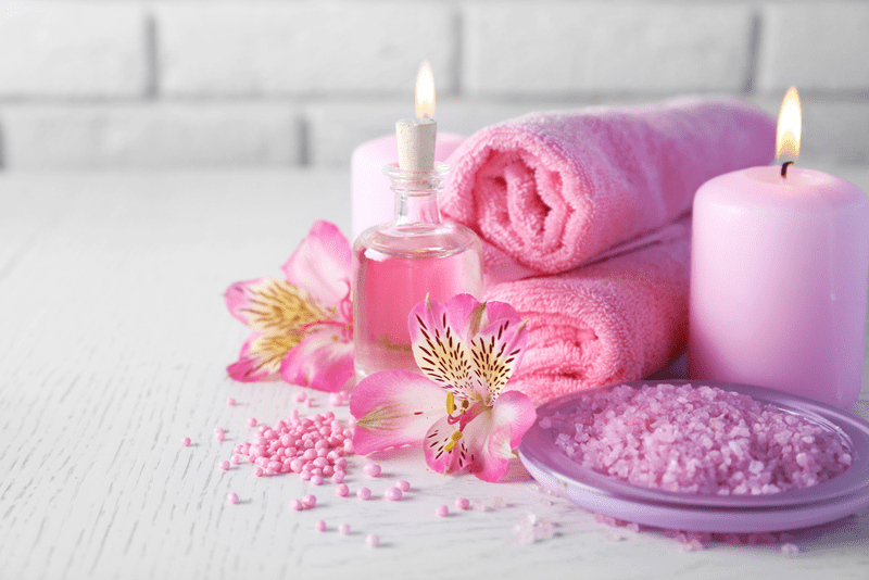 massage towels candle massage salt on table